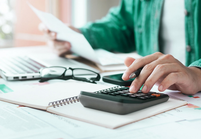 Image of person using calculator