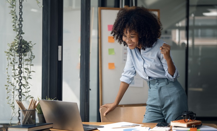 A business woman is excited about her work  in her office