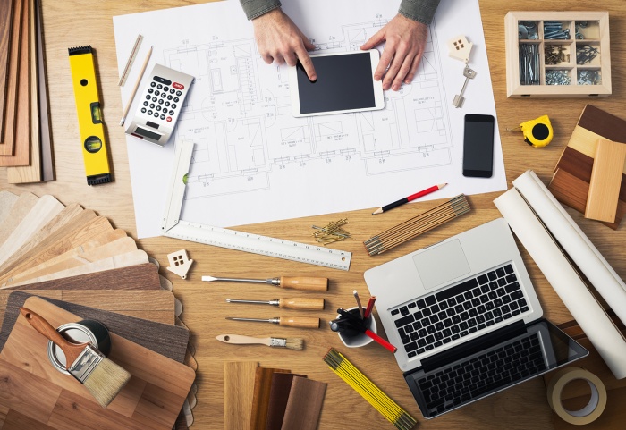 Construction documents and materials cover a desk