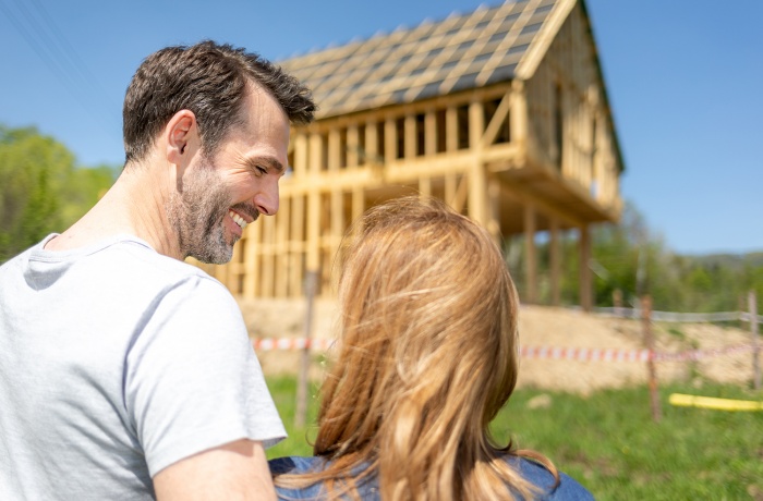 A couple looks at their new home being built