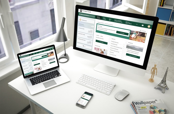 Views of Heritage Family's eBranch on a desktop, a laptop, and a mobile phone.