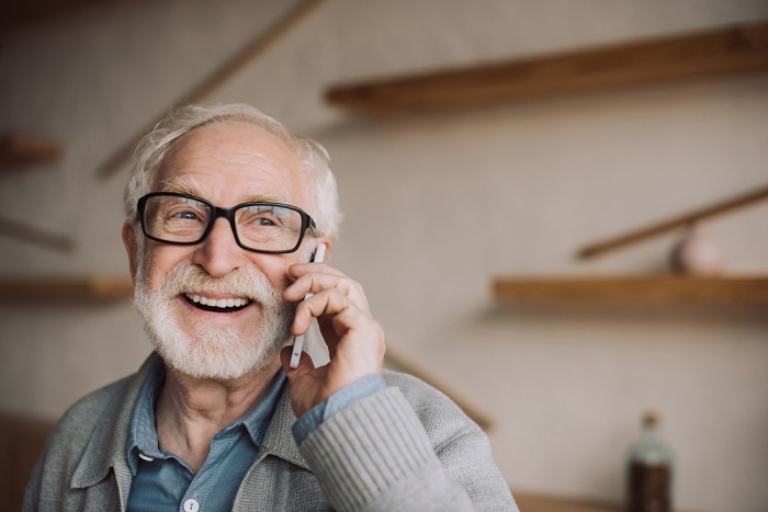 Happy senior man talking on cell phone