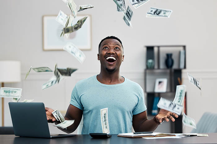 image of a smiling man throwing money up in the air