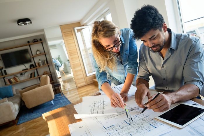 A couple looks over plans to their new house