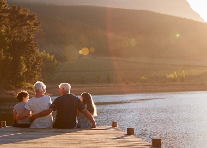 Grandparents enjoy time lakeside with their grandchildren.