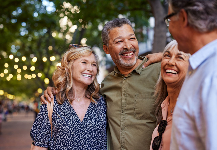 Mature women and men laughing outside