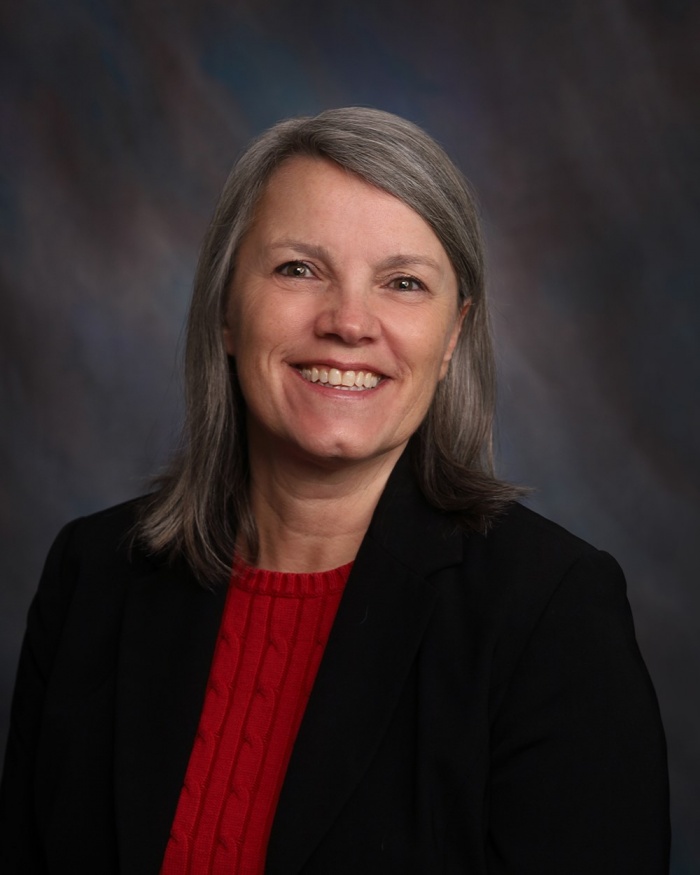 A smiling woman, Robin Mowrey, in business attire