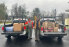 Two community members with stuff a bus items