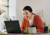 Woman at home browsing on laptop