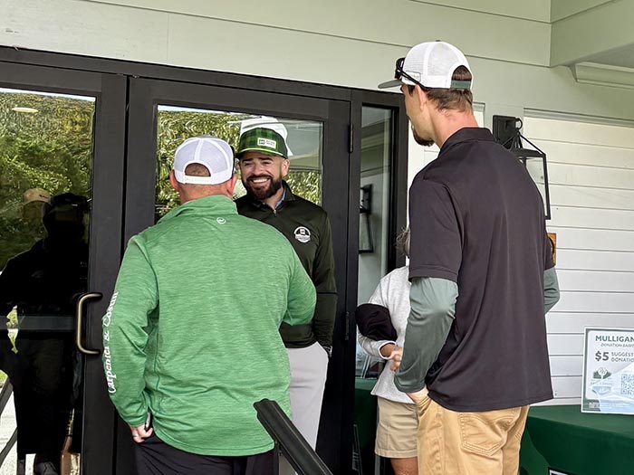 Golfers greeting Chris Gomez